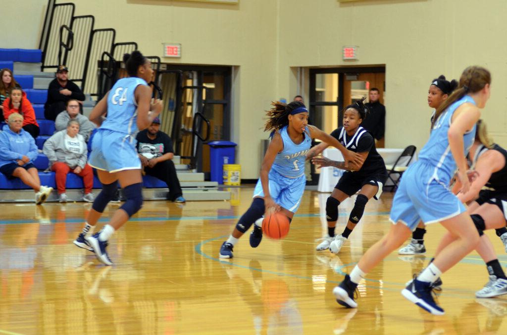 Women's basketball team playing against opponents